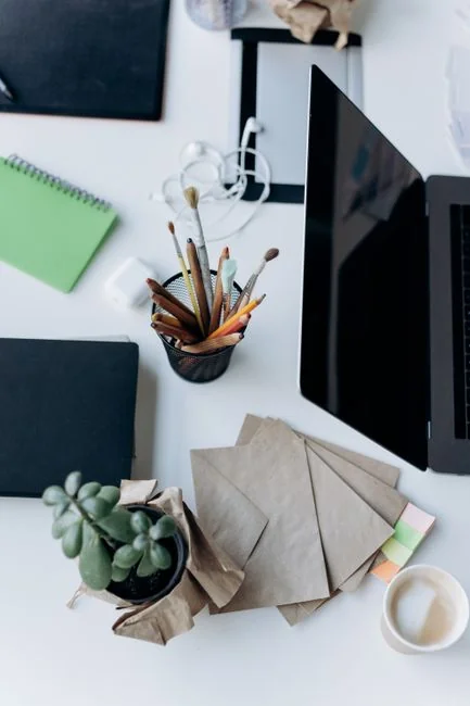 A sleek, productive workspace with several monitors, a laptop, and a smartphone, highlighting a web design project.